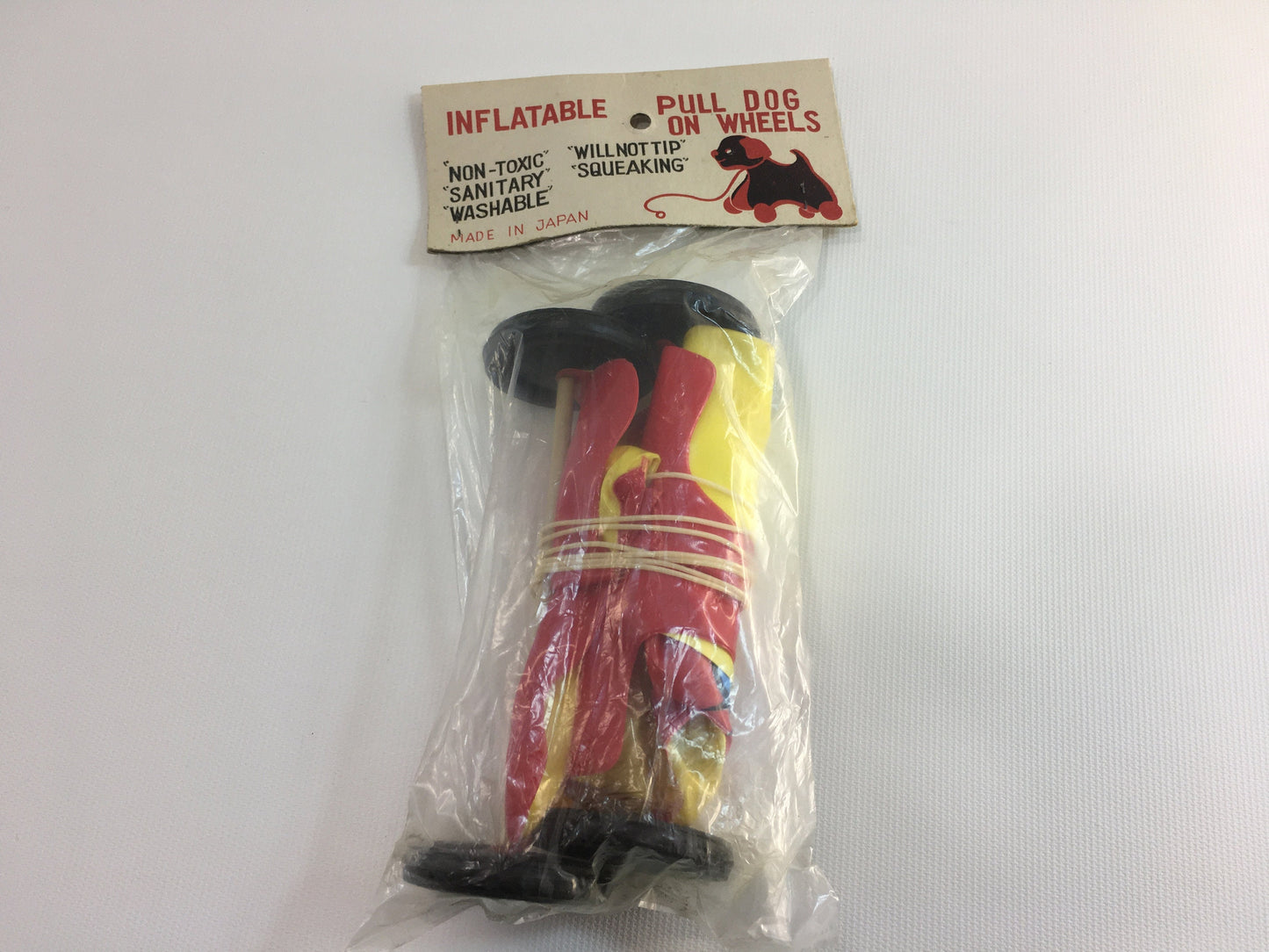 Vintage Pull Dog Toy Inflatable Plastic Red Yellow Toddler Pretend Companion Squeaking Floppy Ears Black Wheels Washable Original Package