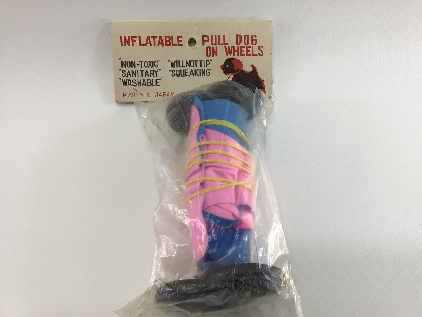 Vintage Pull Dog Toy Inflatable Plastic Pink and Blue Toddler Pretend Companion Squeaking Floppy Ears Black Wheels Washable Original Package